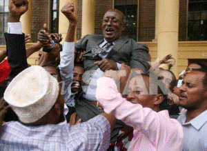 Mandera North MP Aden Mohamed is mobbed by his supporters at the milimani courts after his election was upheld following an election petition.Photo/HEZRON NJOROGE